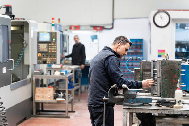 istock Lathe worker man working with a vernier and milling machine in a factory, using a caliper to check measurement. 2180066766