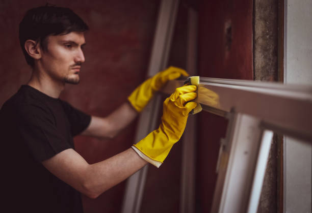 istock Caucasian male builder washes window frames with a sponge. 2180067646