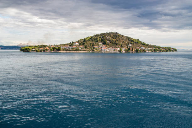 Osljak Island seen from Ugljan island, sunny day with heavy clouds, Dalmatia, Croatia