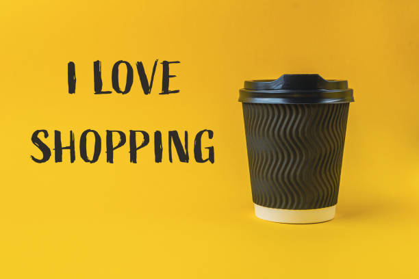 istock Coffee cup with a black lid sits on a yellow background 2180068567