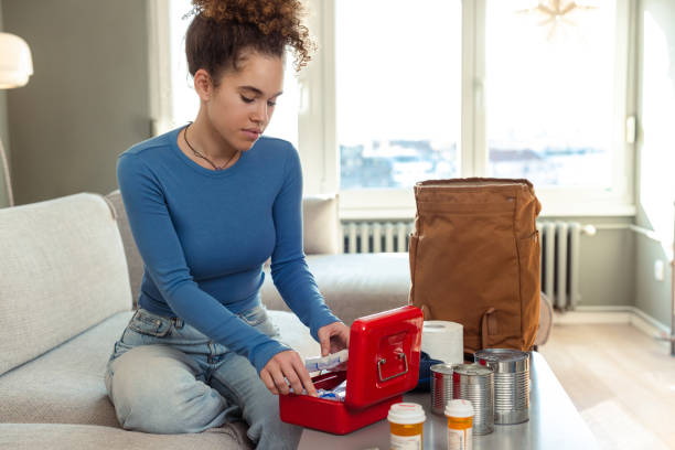 istock Young woman preparing emergency survival kit at home 2180070458