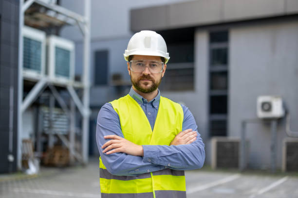 istock Confident construction worker wearing safety helmet and vest at industrial site, emphasizing safety and professionalism 2180074309