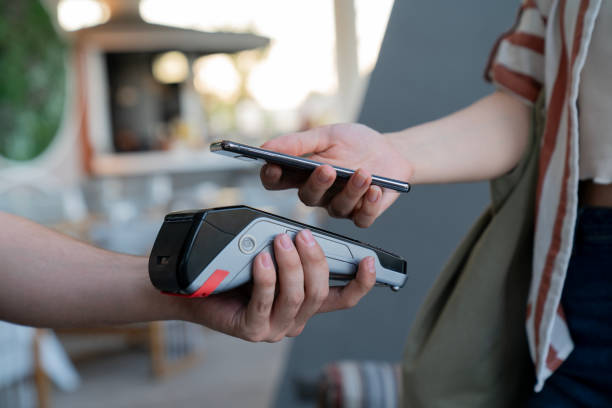istock A person is using a credit card reader to pay for something 2180074716