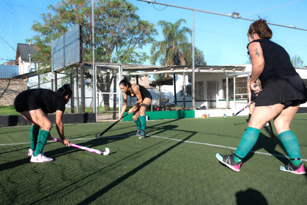 istock Women playing a hockey match 2180075468