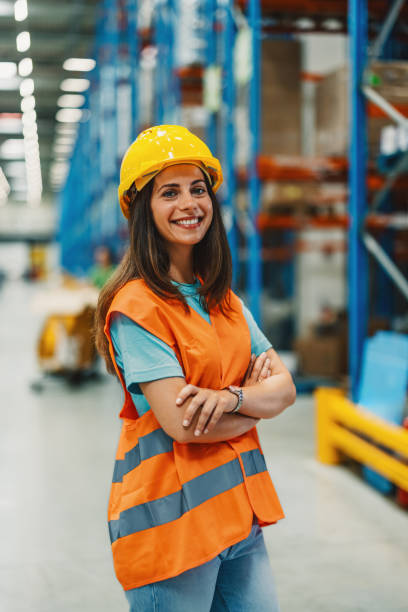 istock Female warehouse worker smiling with crossed arms 2180076633
