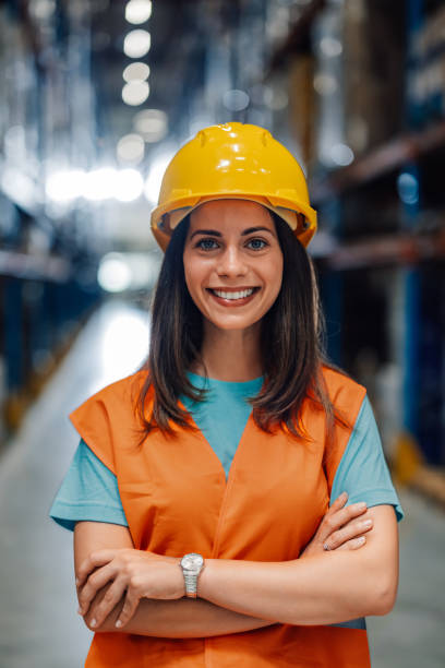 istock Female warehouse worker smiling with crossed arms 2180076693