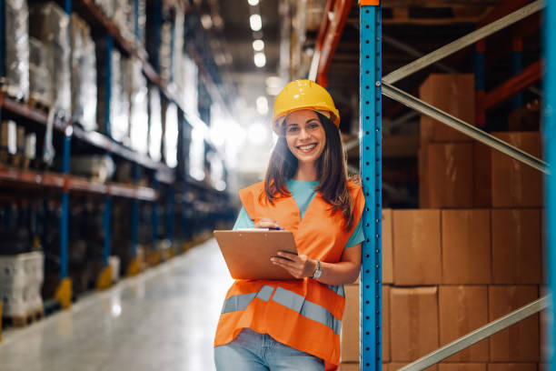 istock Warehouse worker smiling and holding clipboard checking inventory 2180076709