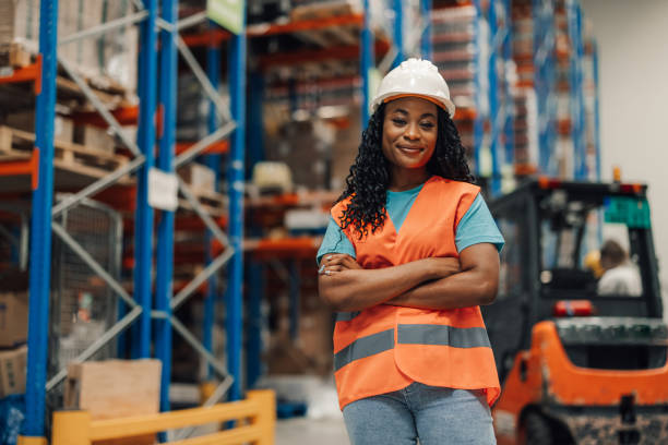 istock Confident female worker posing with arms crossed in warehouse 2180076733