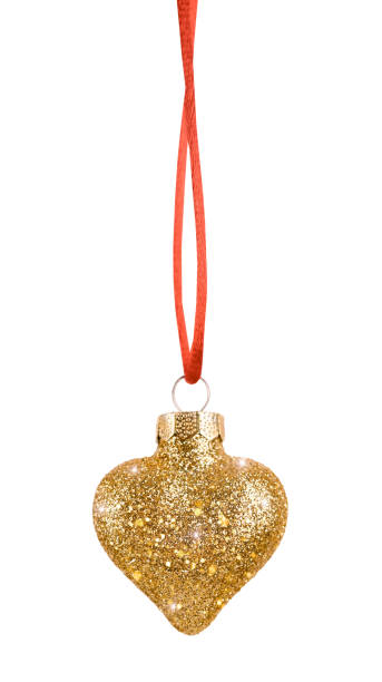 A glitter-covered, gold heart-shaped Christmas ornament, sparkling brightly and hanging from a red ribbon. It features a metallic cap, adding a glamorous and festive touch to holiday decor.