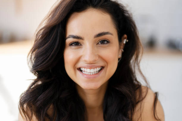 istock Beautiful young woman smiling with perfect white teeth 2180078921
