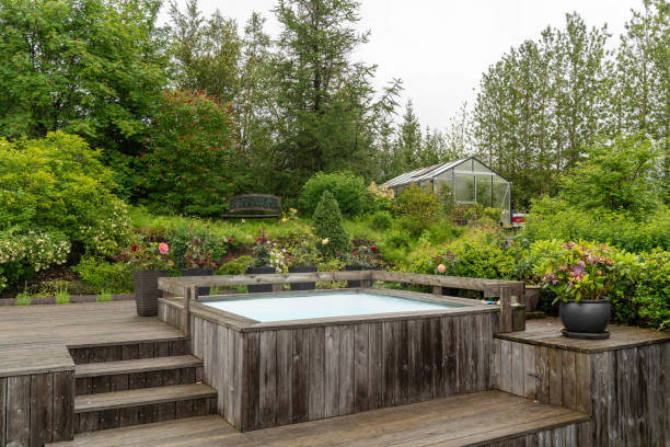 istock Backyard Garden with Wooden Deck and Hot Tub 2180079768
