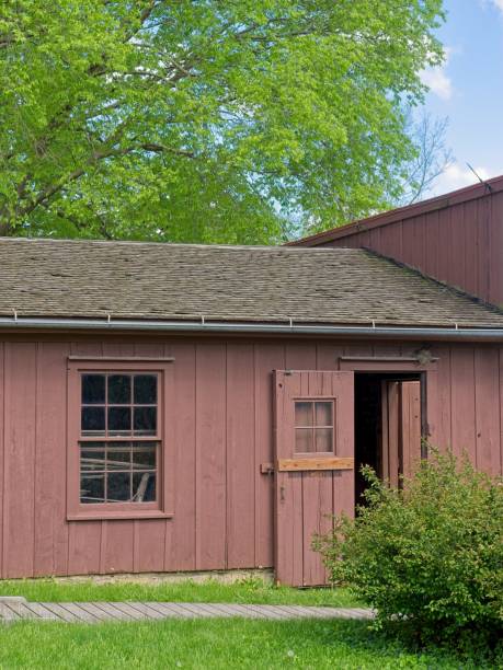 Springtime trees and old barn at Herbert Hoover birthplace historic park. Idyllic old time Americana scene in rural Iowa.