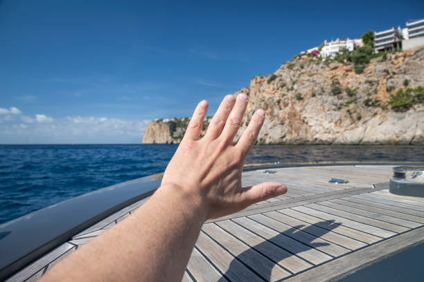 A white speedboat cuts through the serene blue waters of the Mediterranean Sea, leaving a frothy wake behind. Sunlight glints off the water's surface, embodying the spirit of a nautical adventure.