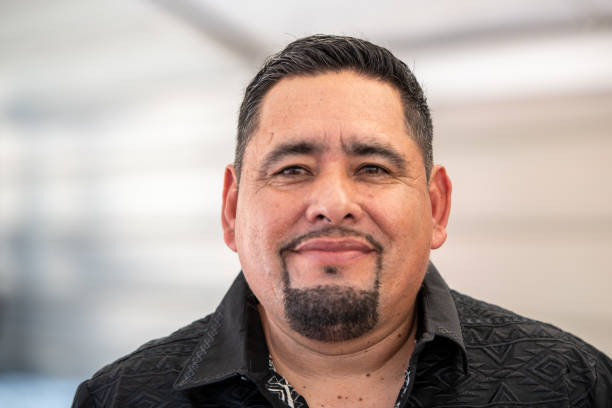 istock Smiling pensive mature hispanic man looking at the camera 2180084271