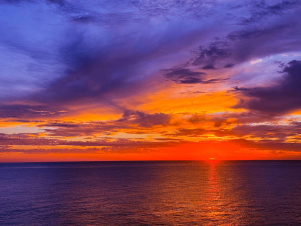 istock Colorful sunset sky over dark ocean at night 2180086008