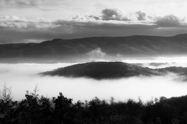 istock White fog surrounding a mountain valley 2180092676