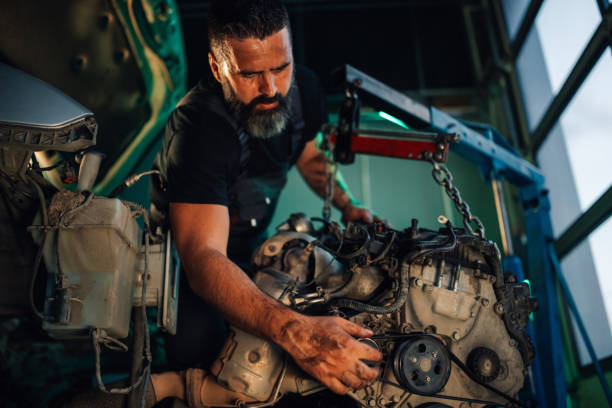 istock Mechanic adjusting components on the car engine with a wrench 2180093081