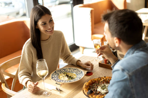 istock Beautiful young couple having romantic lunch together in a restaurant 2180095532