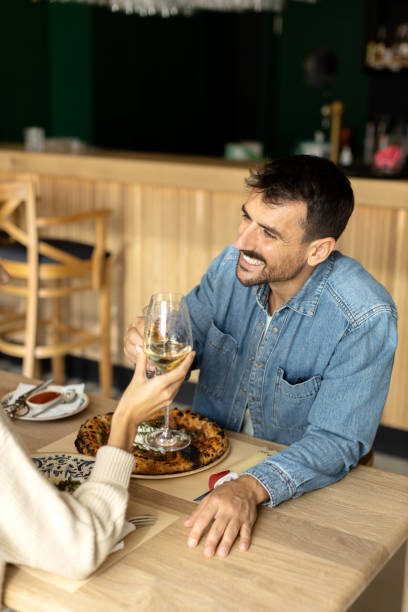 istock Beautiful young couple having romantic lunch together in a restaurant 2180095596