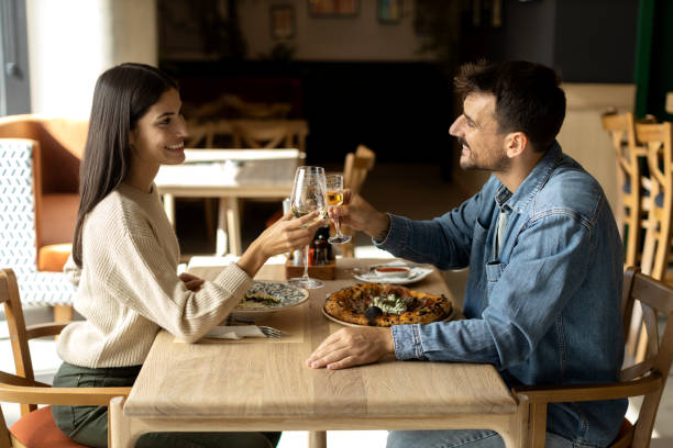 istock Beautiful young couple having romantic lunch together in a restaurant 2180095607