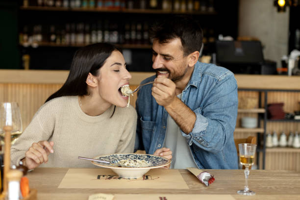 istock Loving couple eating spaghetti at the restaurant 2180095750