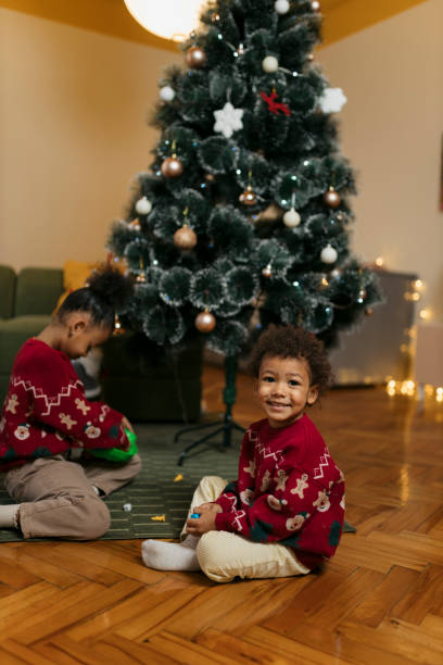 istock Happy little boy playing bunny hop board game by christmas tree 2180095751