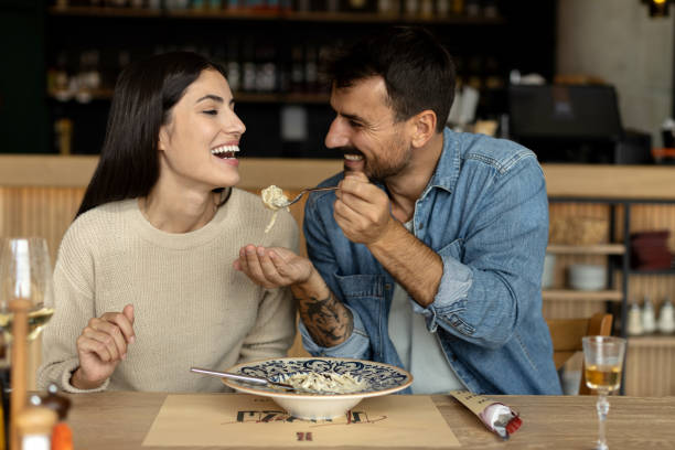istock Loving couple eating spaghetti at the restaurant 2180095768
