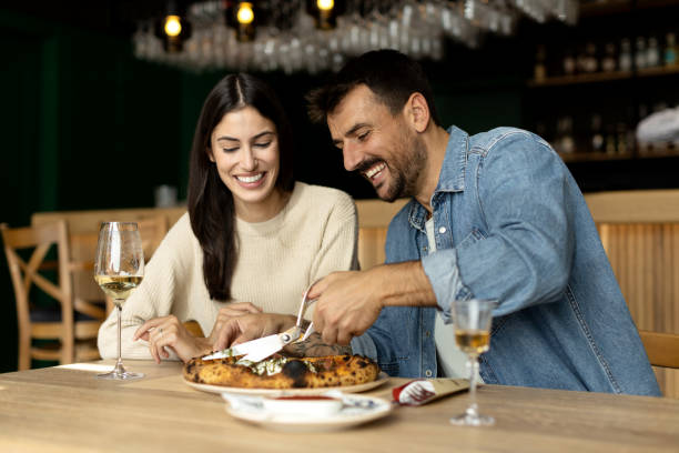 istock Romantic couple enjoying in delicious pizza 2180095916
