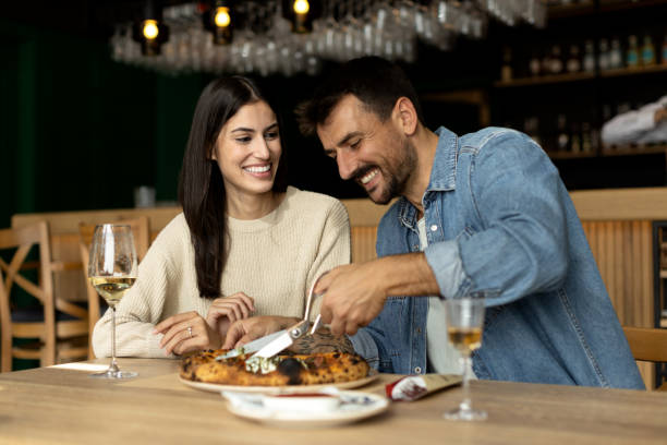 istock Romantic couple enjoying in delicious pizza 2180095936