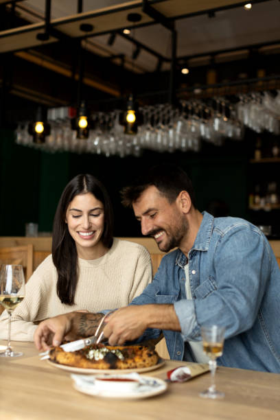 istock Romantic couple enjoying in delicious pizza 2180095946