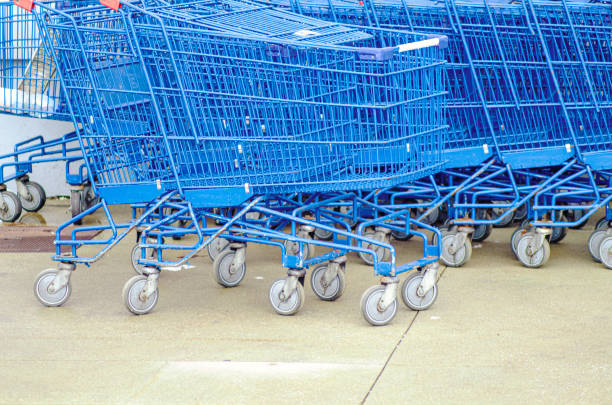 stacked blue supermarket shopping carts made of metal