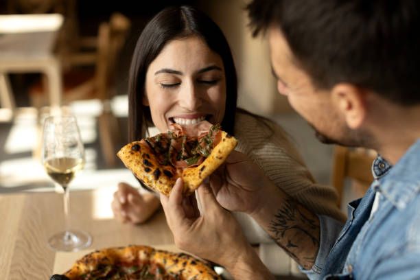 istock Romantic couple enjoying in delicious pizza 2180096069