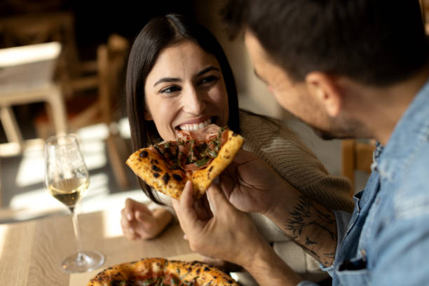 istock Romantic couple enjoying in delicious pizza 2180096079