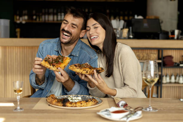 istock Romantic couple enjoying in delicious pizza 2180096151