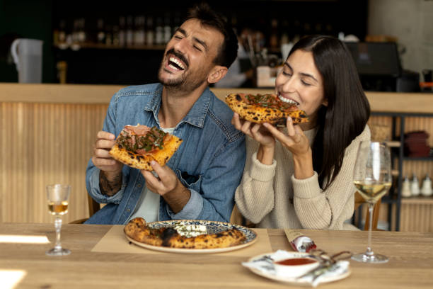 istock Romantic couple enjoying in delicious pizza 2180096199