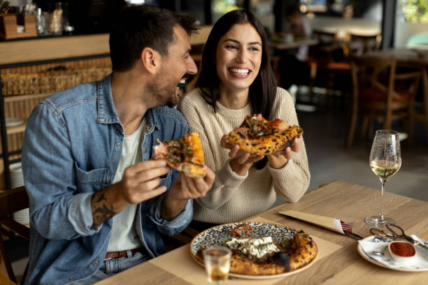 istock Romantic couple enjoying in delicious pizza 2180096219