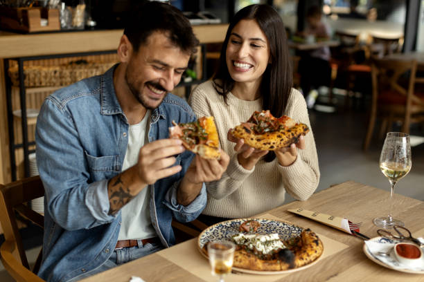 istock Romantic couple enjoying in delicious pizza 2180096220