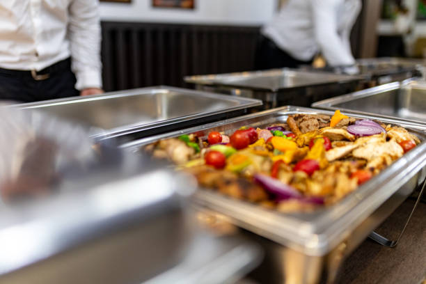 istock Buffet setup with assorted roasted vegetables and meats at a corporate event in a modern dining hall 2180096373