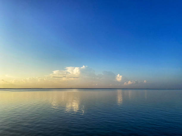 istock Low clouds against a blue sky where sky and water meet at the horizon 2180096428