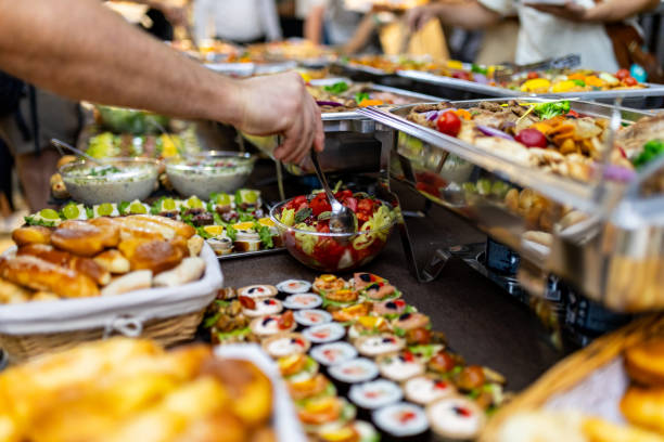 istock A person is serving themselves a salad from a buffet table filled with many different types of food 2180096556