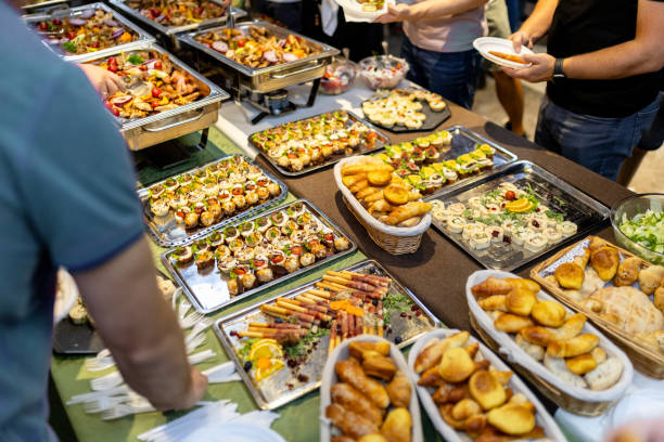 istock Catering buffet spread featuring a variety of appetizers at an event in a lively setting during a summer evening gathering 2180096569