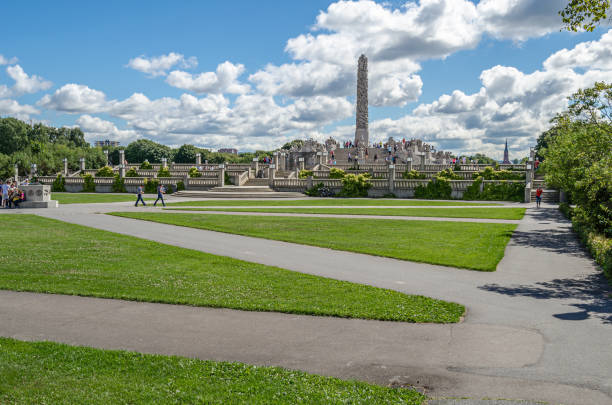 Oslo, Norway - July 18, 2014: People visiting Frogner Park in Oslo, Norway, famous for the Vigeland installation of sculptures created by Gustav Vigeland from the 1920s until his death (1943)