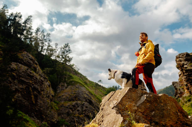 istock Man hiker with his dog 2180100482