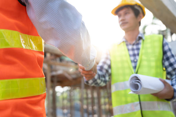 istock Construction team hands shaking greeting start up plan new project contract in office center at construction site, industry ,architecture, partner, teamwork, agreement, property, contacts. 2180105751