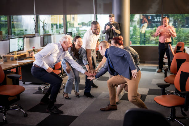 istock Diverse Team Engages in Celebratory Office Huddle 2180110271