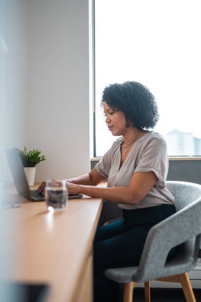 istock Professional Hispanic Woman Engaged in Laptop Work at Office 2180111887
