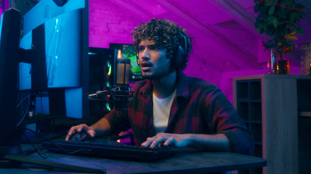 istock Indian Muslim Arabian man streamer playing video game addict computer shout scream broadcast radio host excited guy stuck cyber sport microphone blog cyberspace influence headphones monitor male glued 2180112741