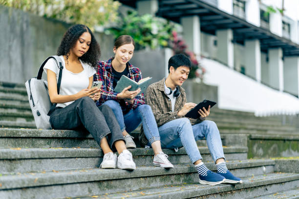 istock Multiethnic college students reading books on laptops, preparing for exams or group work on campus, using modern devices for studying. 2180117713
