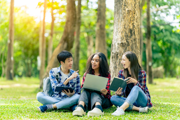 istock Multiethnic college students reading books on laptops, preparing for exams or group work on campus, using modern devices for studying. 2180117733