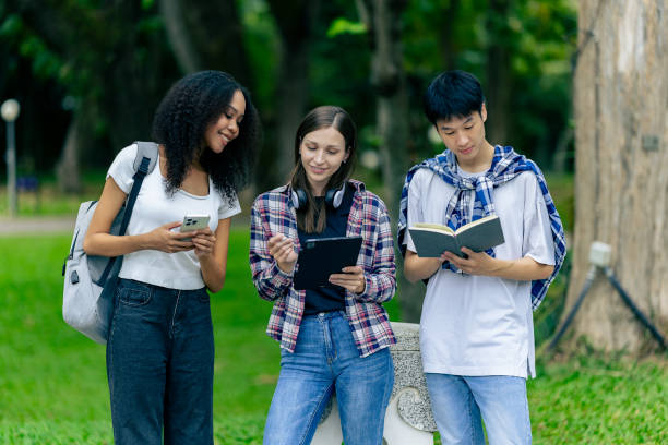 istock Multiethnic college students reading books on laptops, preparing for exams or group work on campus, using modern devices for studying. 2180117758
